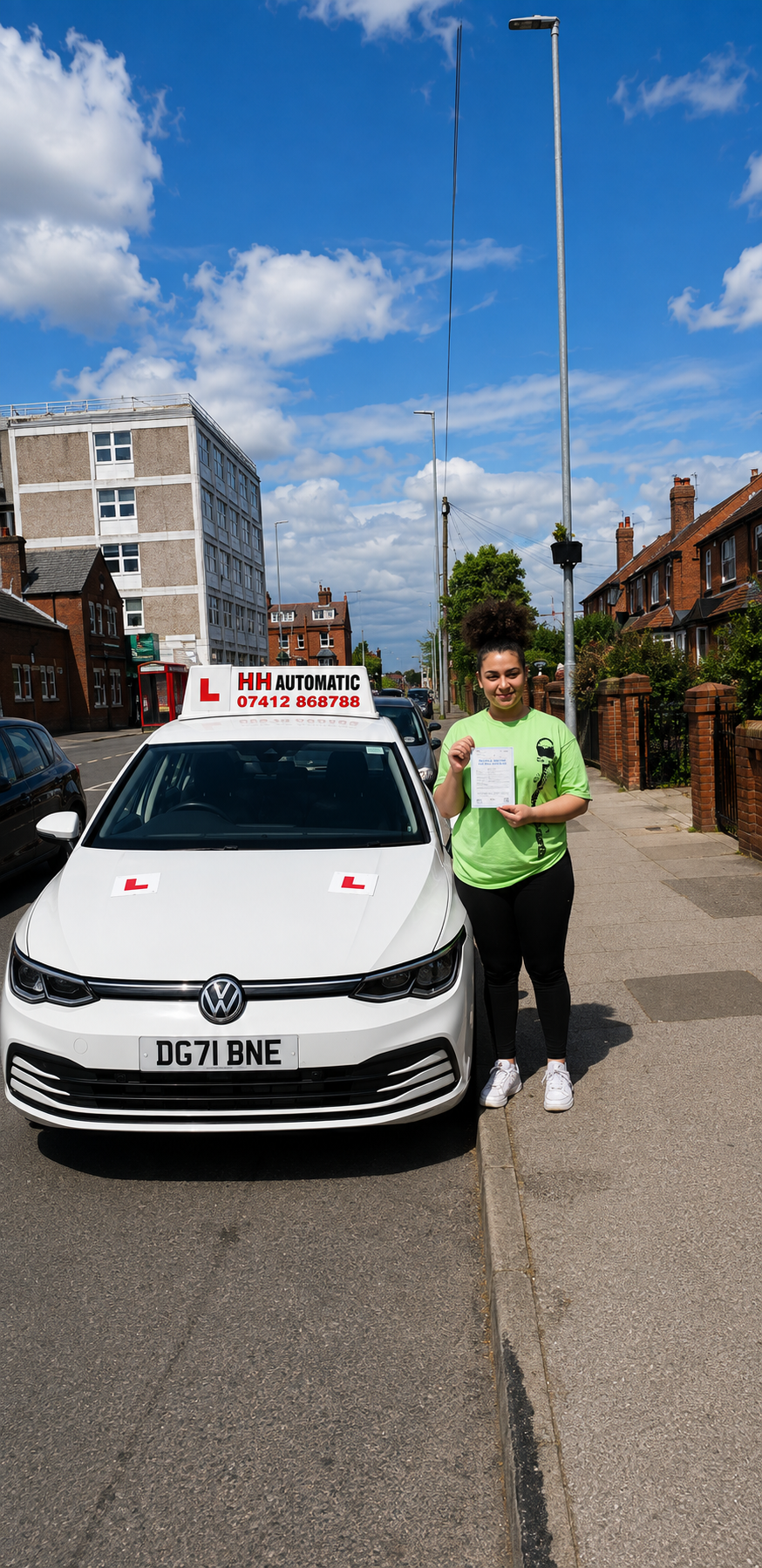 Learner holding test pass paper